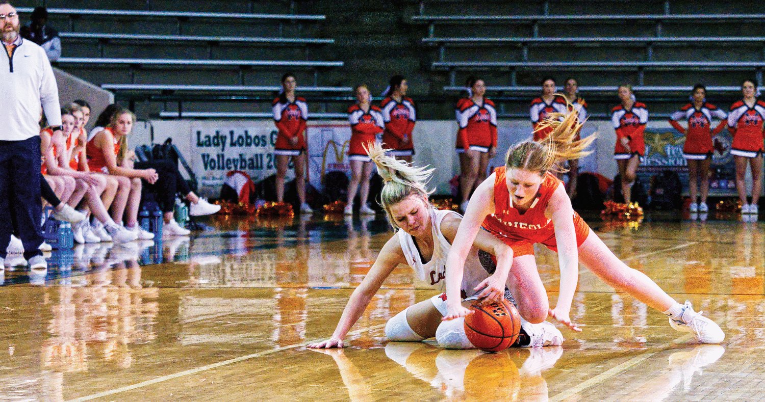Mineola guard Macy Fischer goes to the floor, fighting Winnsboro's Faith Sechrist for the loose ball. [see more shots, buy basketball photos]
